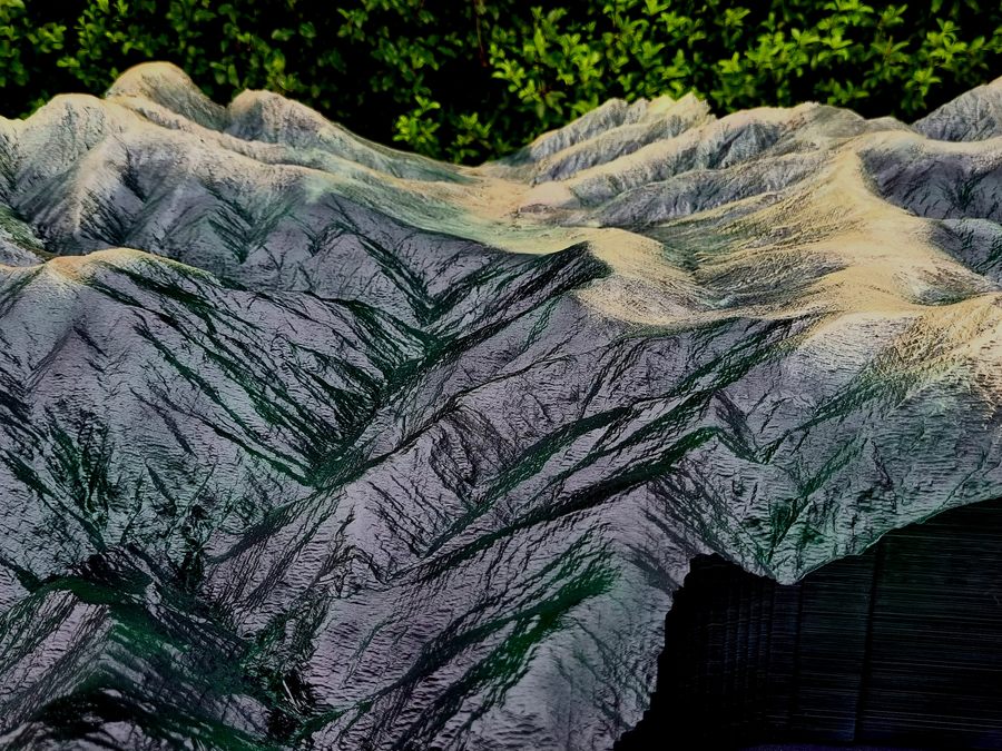 Close up of a hand painted 3D printed terrain model showing every spur and gut