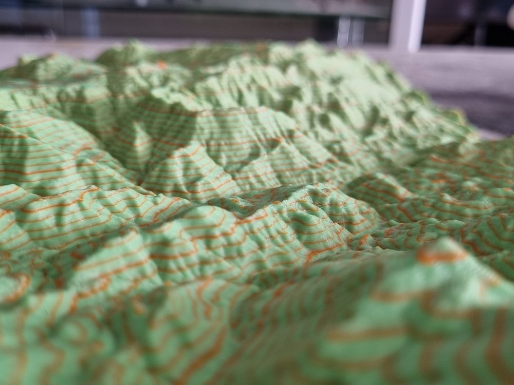 3D printed terrain model with contour lines picked out in colour