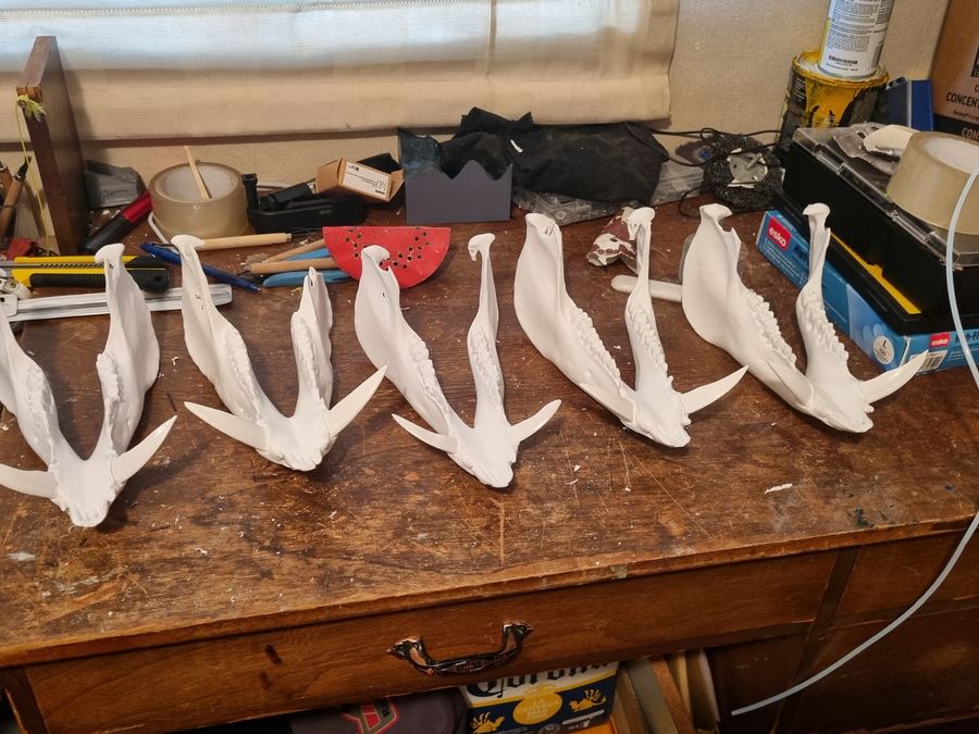 A row of printed antler replicas on the workbench